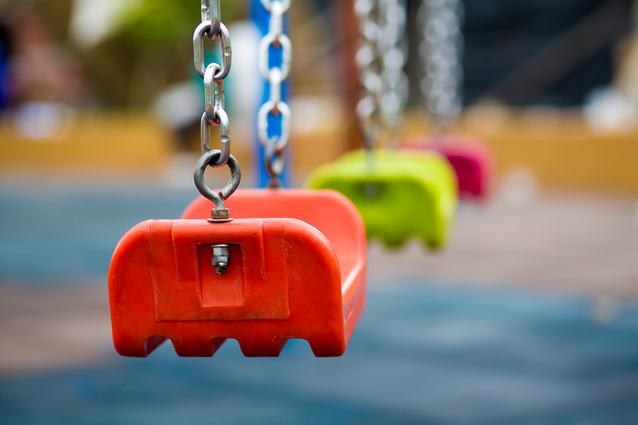 Close up of empty swing in a playground
